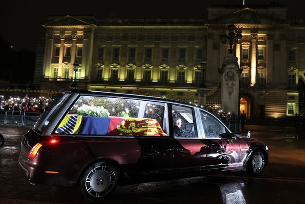 The hearse carrying the coffin of Queen Elizabeth II arrives at Buckingham Palace, London, where it will lie at rest overnight in the Bow Room. Picture date: Tuesday September 13, 2022.