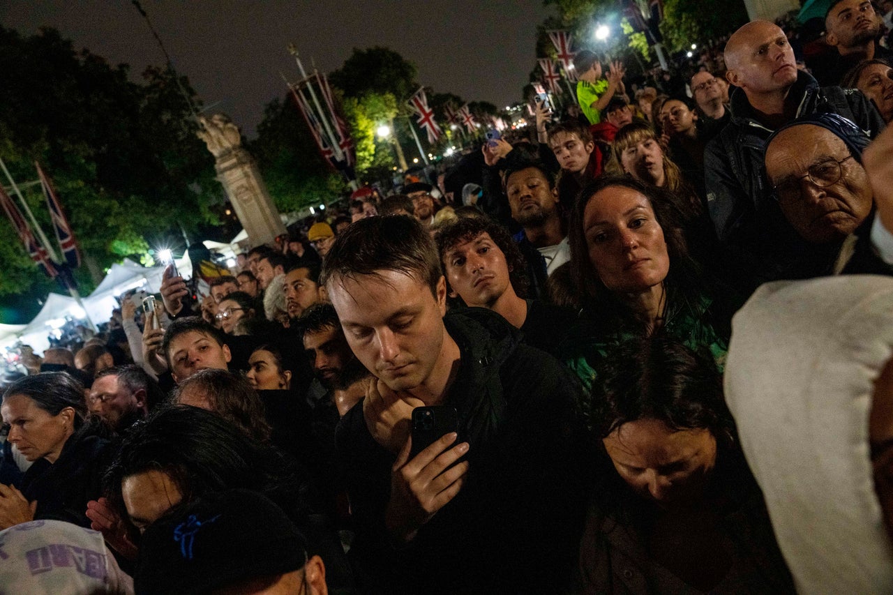People gather to pay respects.