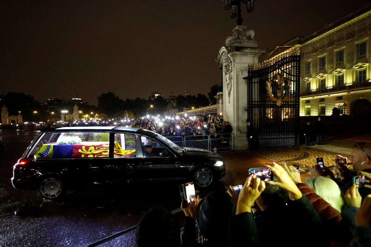 People watch the hearse carrying the coffin of Britain's Queen Elizabeth on Sep. 13.