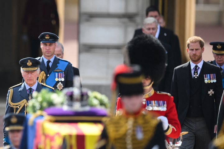 Prince William and Prince Harry walk behind the coffin of Queen Elizabeth II, adorned with a Royal Standard and the Imperial State Crown and pulled by a Gun Carriage of The King's Troop Royal Horse Artillery.