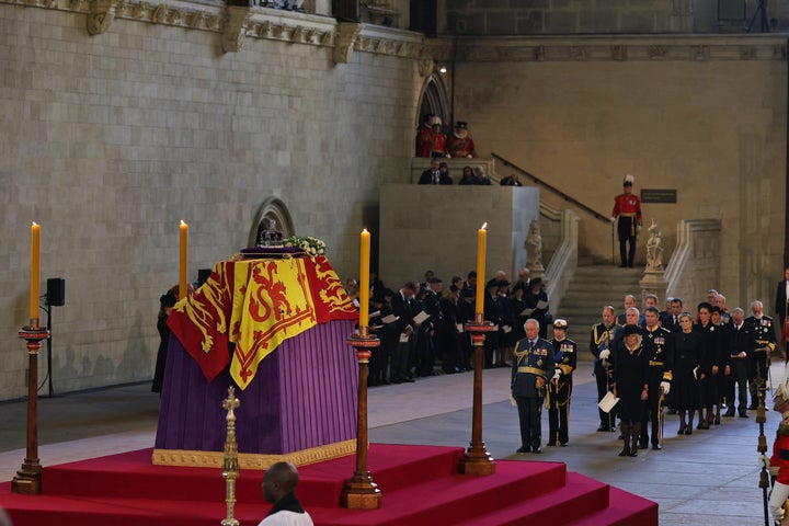 A general view as the coffin carrying Queen Elizabeth II rests in Westminster Hall for the Lying-in State on September 14, 2022 in London, England, with members of the royal family behind the coffin.