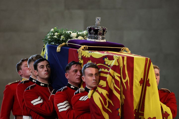 Pallbearers from The Queen's Company, 1st Battalion Grenadier Guards places the coffin of Britain's Queen Elizabeth II on a Catafalque inside Westminster Hall.