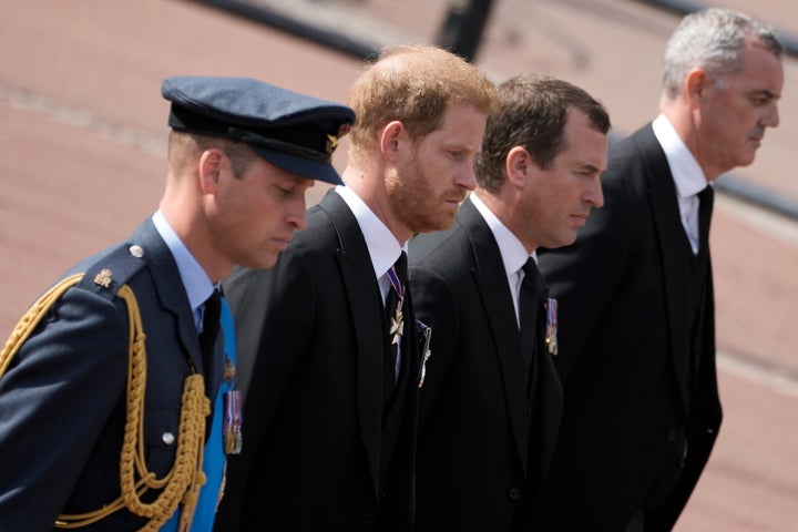 Prince William, left, and Prince Harry, second left, follow the coffin of Queen Elizabeth II.