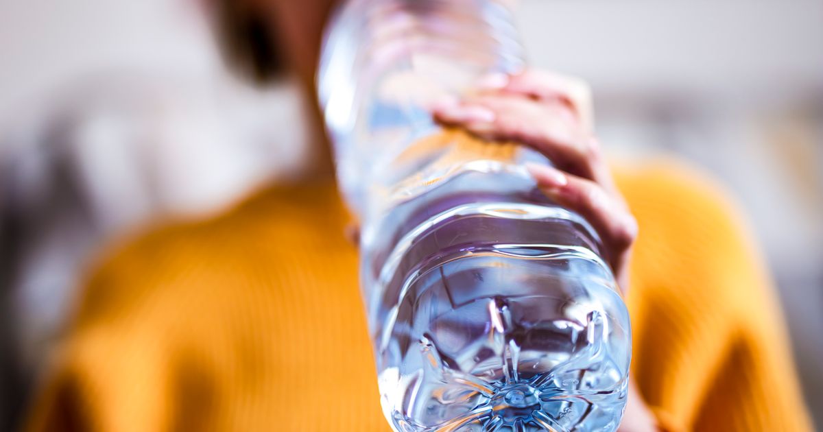 Hand Holding 1 Gallon Plastic Bottle Of Drinking Water Stock Photo