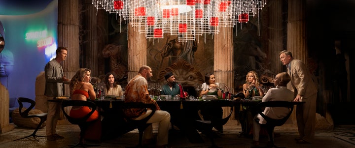 (Left to right) Edward Norton, Madelyn Cline, Kathryn Hahn, Dave Bautista, Leslie Odom Jr., Jessica Henwick, Kate Hudson, Janelle Monae and Daniel Craig gather at the table for the final "Knives out" Detective story.