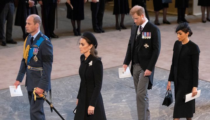 Prince William, Prince of Wales, Catherine, Princess of Wales, Harry, Duke of Sussex and Meghan, Duchess of Sussex arrive as the coffin bearing the body of Her majesty Queen Elizabeth II completes its journey from Buckingham Palace to Westminster Hall accompanied by King Charles III and other members of the Royal Family.