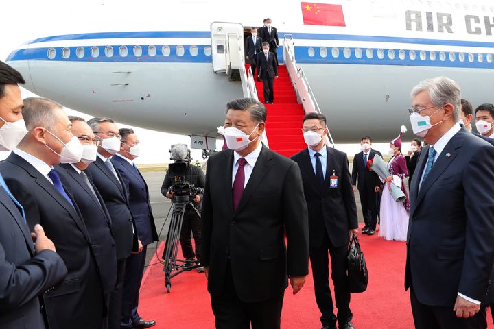 In this photo released by Xinhua News Agency, Chinese President Xi Jinping, center, is met by Kazakhstan's President Kassym-Jomart Tokayev, right, as he arrives at the Nur-sultan Nazarbayev International Airport for a state visit, on Sept. 14, 2022, in Nur-Sultan, Kazakhstan. 
