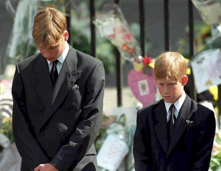 Prince William (left) and Prince Harry, the sons of Diana, Princess of Wales, bow their heads as their mother's coffin is taken out of Westminster Abbey following her funeral service.