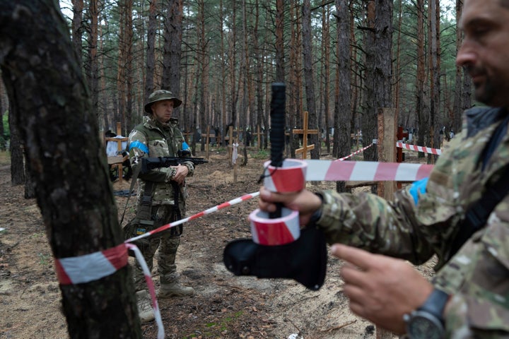 Oleg Kotenko, the Commissioner for Issues of Missing Persons under Special Circumstances looks at the unidentified graves of civilians and Ukrainian soldiers in the recently retaken area of Izium, Ukraine, on Sept. 15, 2022 who had been killed by Russian forces near the beginning of the war.