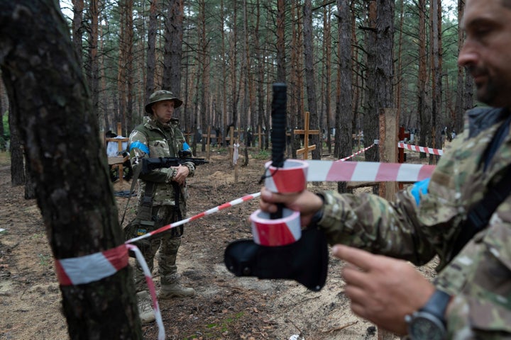 Oleg Kotenko, the Commissioner for Issues of Missing Persons under Special Circumstances looks at the unidentified graves of civilians and Ukrainian soldiers in the recently retaken area of Izium, Ukraine, on Sept. 15, 2022 who had been killed by Russian forces near the beginning of the war. 