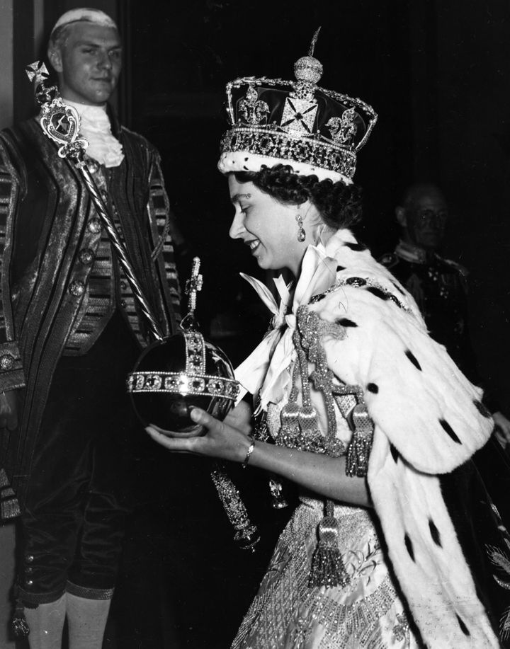 Queen Elizabeth II wearing the Imperial state Crown and carrying the Orb and sceptre during her 1953 coronation