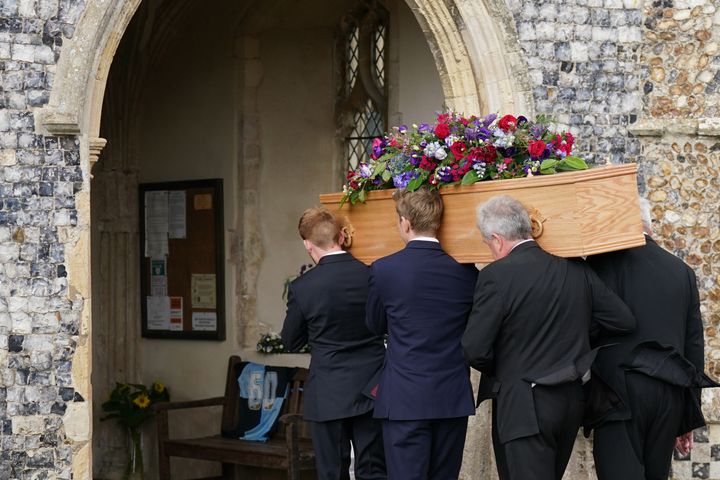Pallbearers carry the coffin of TV presenter and journalist Bill Turnbull into Holy Trinity Church in Blythburgh, Suffolk for his funeral