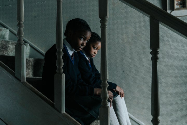 (From left) The sisters (Leah Mondesir Simmons and Eva-Arianna Baxter) watch their family from a distance in their childhood home.