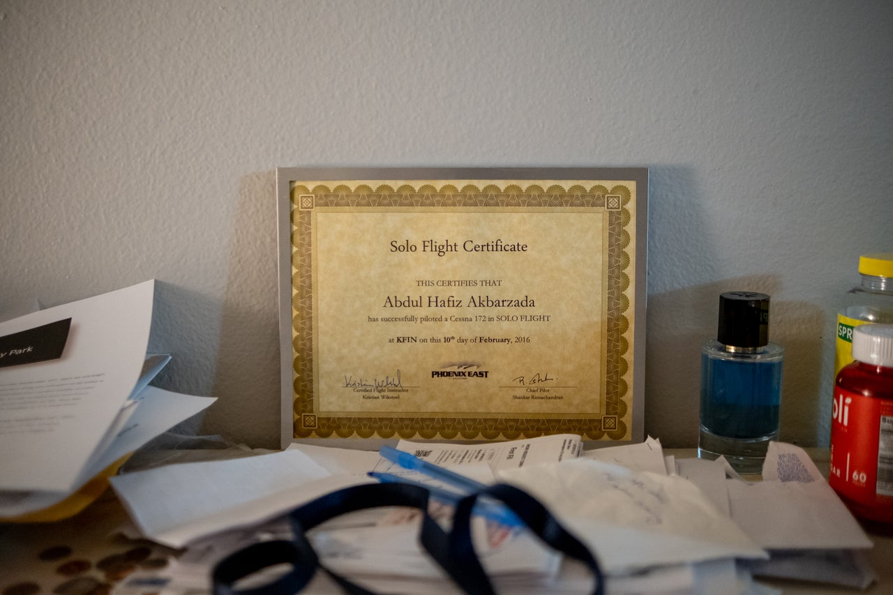 A flight certificate sits framed on Hafiz Akbarzada and his wife’s dresser in their new Colorado apartment on Sept. 12, 2022.