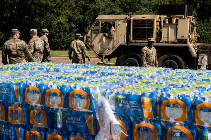 JACKSON, MS - SEPTEMBER 01: A truck carrying non-potable water, water that can be used for flushing toilets and cleaning but not drinking, arrives at Thomas Cardozo Middle School where personnel from the Mississippi National Guard were also handing out bottled water in response to the water crisis on September 01, 2022 in Jackson, Mississippi. Jackson has been experiencing days without reliable water service after river flooding caused the main treatment facility to fail.