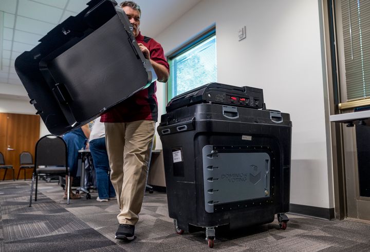 BURNSVILLE, MN - AUGUST 03: An election judge sets up a Dominion voting machine during a public accuracy test of voting equipment on August 3, 2022 in Burnsville, Minnesota. State officials have reiterated their commitment to secure and accurate elections as election integrity is subject to growing public scrutiny. (Photo by Stephen Maturen/Getty Images)