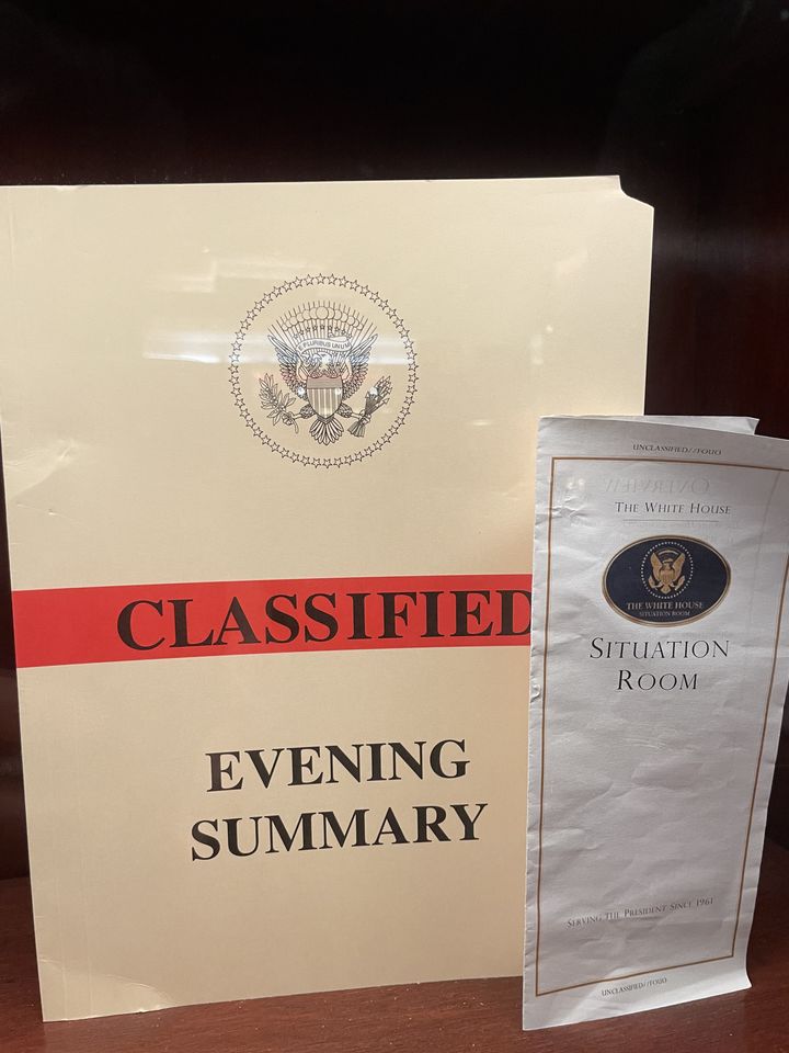 A folder marked "Classified" and "Evening Summary" and a Situation Room brochure are on display at the bar in the lobby of Trump Tower in Manhattan.