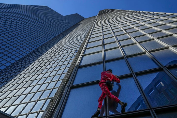 Alain Robert said he wanted to call attention to climate change when he climbed the 48-story skyscraper in Paris.