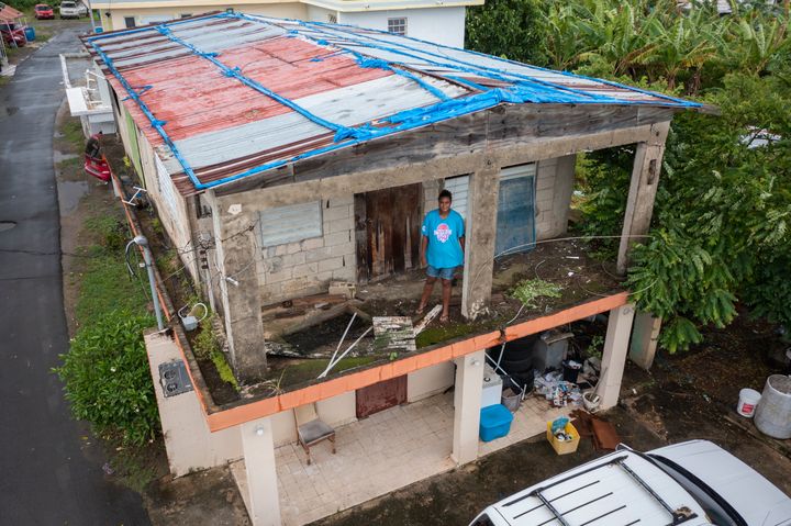 Jetsabel Osorio stands in her house damaged five years ago by Hurricane Maria before the arrival of Tropical Storm Fiona in Loiza, Puerto Rico, Saturday, Sept. 17, 2022. (AP Photo/Alejandro Granadillo)