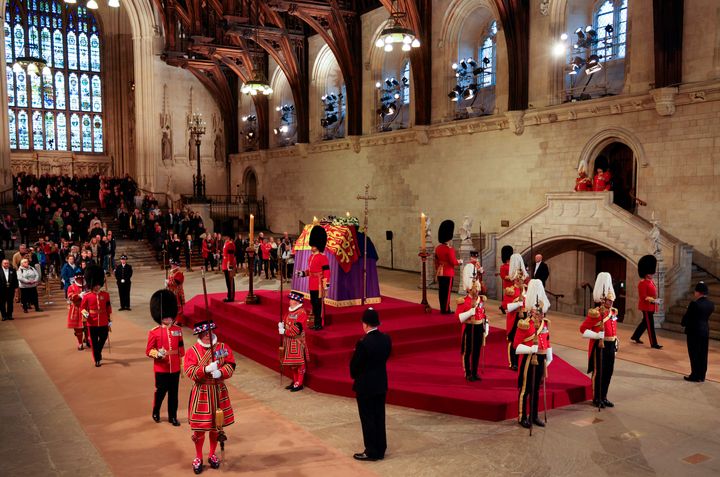 The King's Body Guard, formed of Gentlemen at Arms, Yeomen of the Guard and Scots Guards, change guard duties around the coffin of Queen Elizabeth II, Lying in State inside Westminster Hall, at the Palace of Westminster in London, Sunday, Sept. 18, 2022. (Adrian Dennis/Pool Photo via AP)