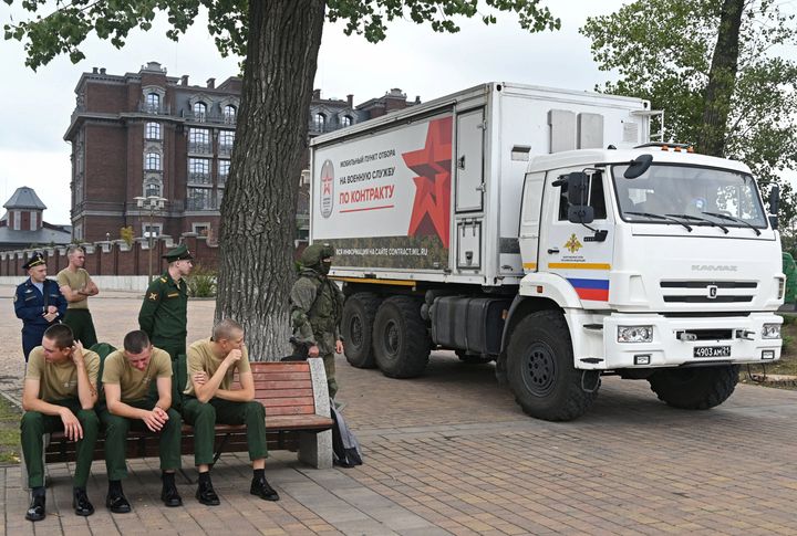 Russian service members sit next to a mobile recruitment center for military service under contract in Rostov-on-Don, Russia September 17, 2022. REUTERS/Sergey Pivovarov