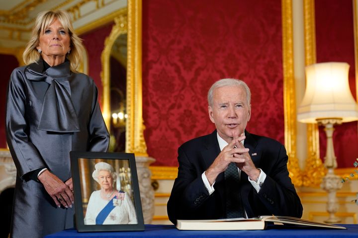 President Joe Biden speaks after signing a book of condolence at Lancaster House in London, following the death of Queen Elizabeth II, Sunday, Sept. 18, 2022, as first lady Jill Biden looks on. (AP Photo/Susan Walsh)