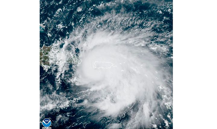 This satellite image provided by NOAA shows Hurricane Fiona in the Caribbean on Sunday, Sept. 18, 2022. The eye of newly formed Hurricane Fiona is near the coast of Puerto Rico — and it has already sparked an island-wide blackout and threatens to dump “historic” levels of rain. (NOAA via AP)