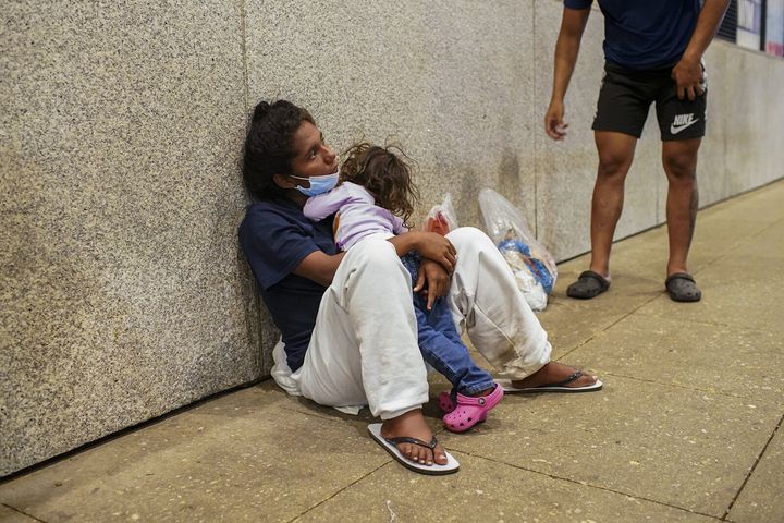 Ana Ramirez Duran, 22, who says she is 8 months' pregnant, holds her 3-year-old daughter after arriving on a bus from Texas with other migrants at Union Station in Chicago on Aug. 31.