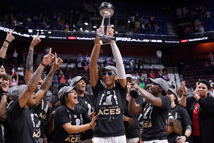 Las Vegas Aces' A'ja Wilson holds up the championship trophy as the team won the WNBA basketball finals against the Connecticut Sun.