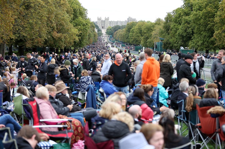 Mourners sitting on fold out chairs ahead of the State Funeral for Queen Elizabeth II on September 19, 2022 in Windsor, England.