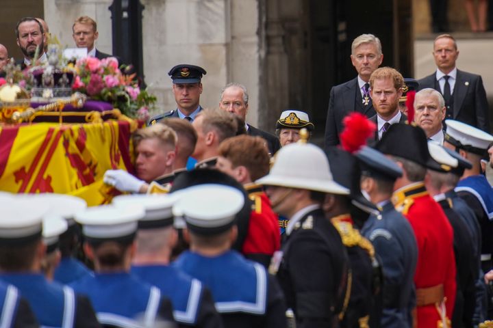 Prince William and Prince Harry watch as the coffin of Queen Elizabeth II is placed on a gun carriage ahead of the state funeral. 