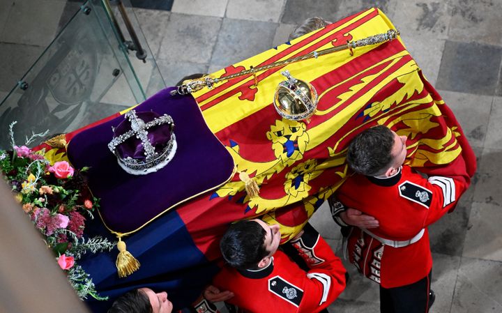 The Queen's coffin with the Imperial State Crown resting on top is carried into Westminster Abbey.