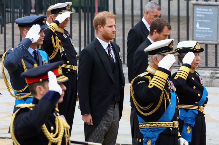 Prince Harry does not salute. 