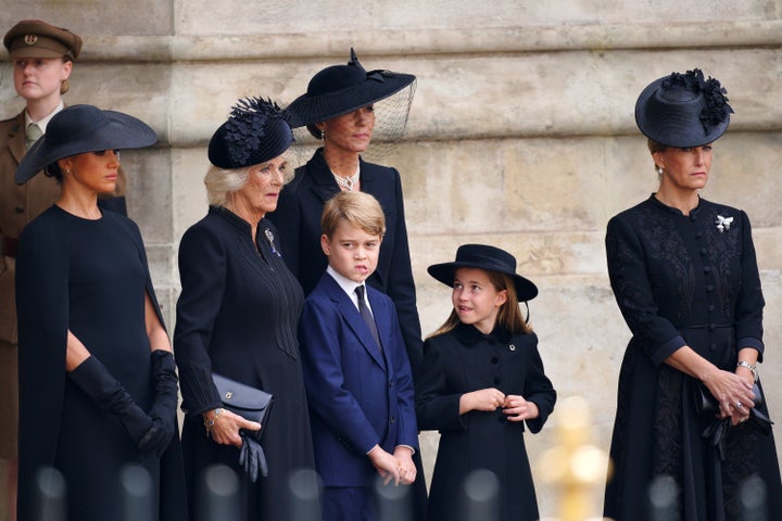 The Duchess of Sussex, the Queen Consort, Prince George, the Princess of Wales, Princess Charlotte and the Countess of Wessex leaving the state funeral.