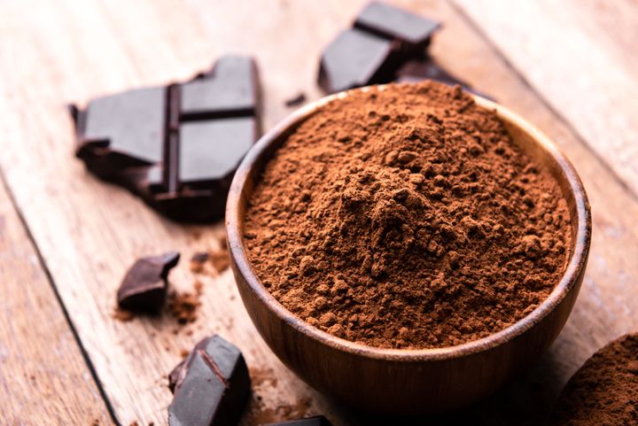 crude dark cocoa powder in a brown bowl