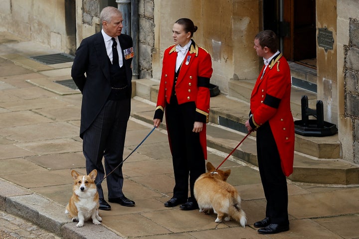 Britain's Prince Andrew with royal corgis as they await the cortege on the day of the state funeral and burial of Queen Elizabeth.