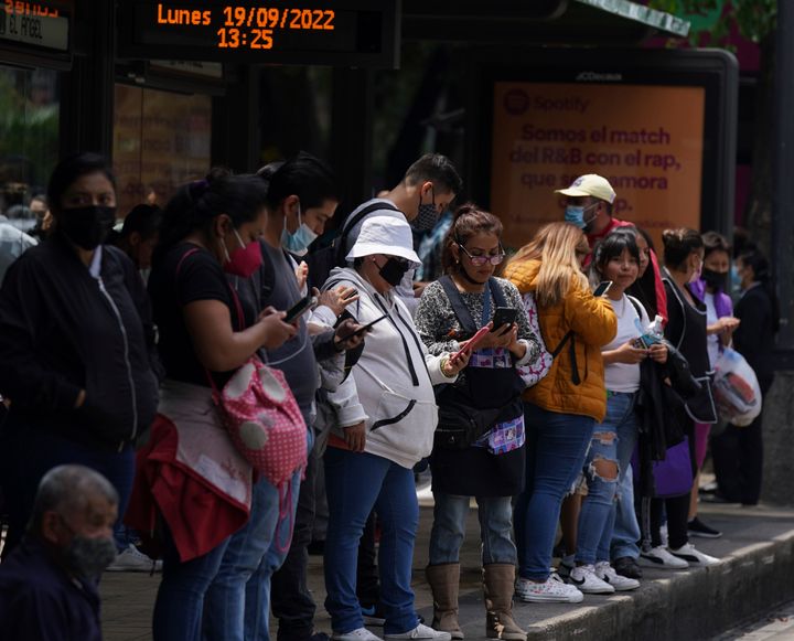 People gather outside at a bus stop after a magnitude 7.6 earthquake was felt in Mexico City, Monday, Sept. 19, 2022. (AP Photo/Fernando Llano)