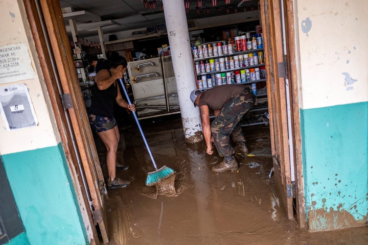 Employees remove mud from a hardware store in the aftermath of Hurricane Fiona in Salinas, Puerto Rico, on Monday.