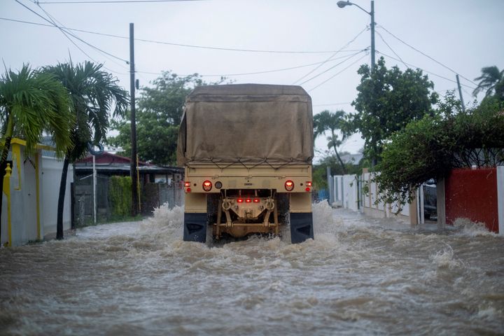 A Puerto Rico National Guard truck drives through a flooded street Monday in Salinas searching for people needing to be rescued.