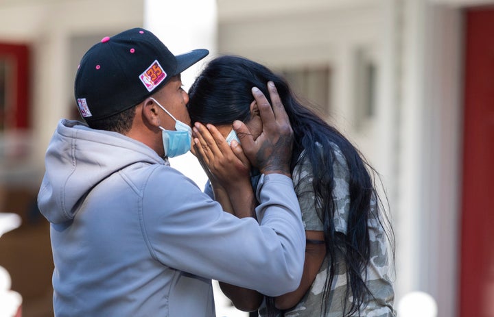 Rafael Eduardo, an undocumented immigrant from Venezuela, hugs another immigrant Thursday outside St. Andrews Episcopal Church on Martha's Vineyard.