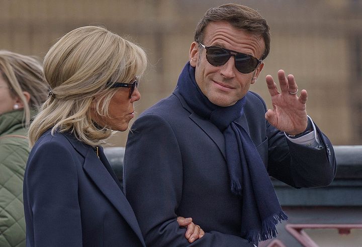 French President Emmanuel Macron waves as he and his wife Brigitte Macron in London for the Queen's funeral. 