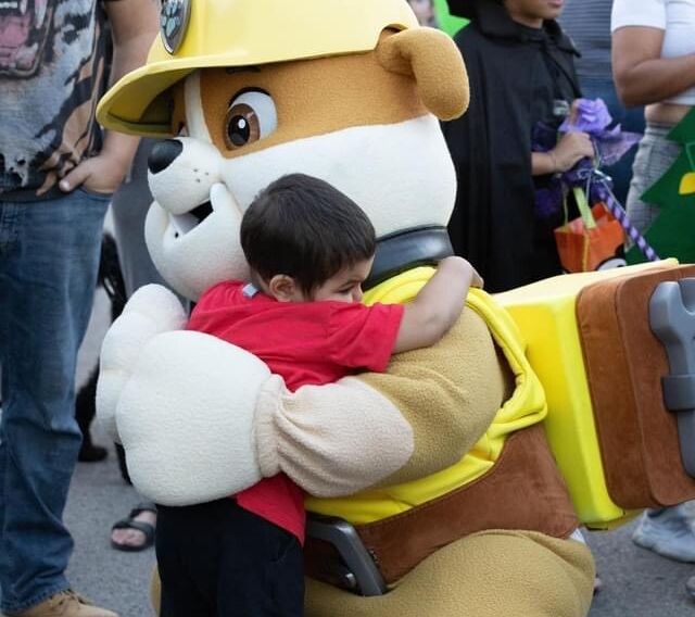 Alex Hurdakis, 5, hugs a character from "Paw Patrol" at a neighborhood Halloween celebration thrown in his honor in Hamilton, Ontario.