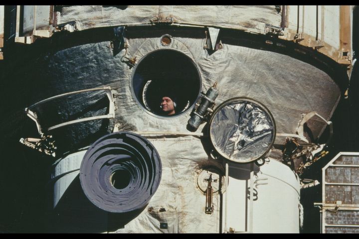 A photograph  of Polyakov taken arsenic  the Space Shuttle "Discovery" docked with the Mir abstraction  station.