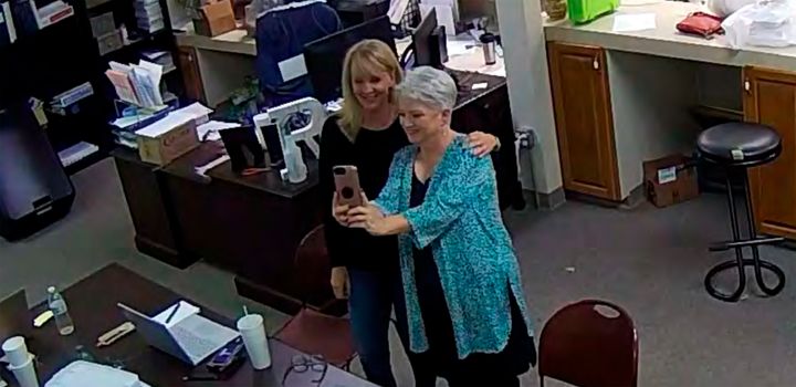 In this Jan. 7, 2021, image taken from Coffee County, Ga., security video, Cathy Latham (right) appears to take a selfie with a member of a computer forensics team inside the local elections office. (Coffee County, Georgia via AP)