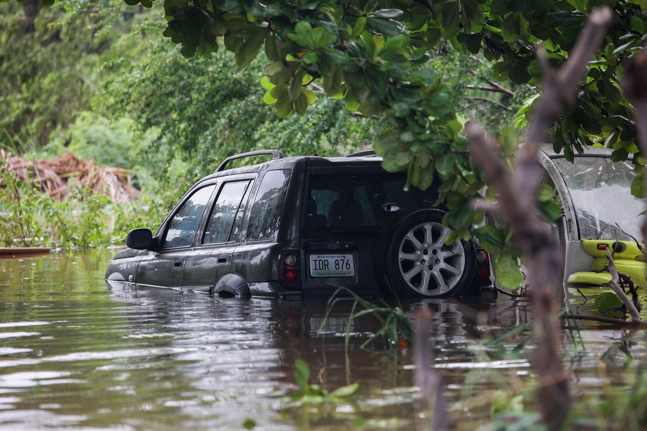 A vehicle is submerged in Salinas, Puerto Rico, on Monday.