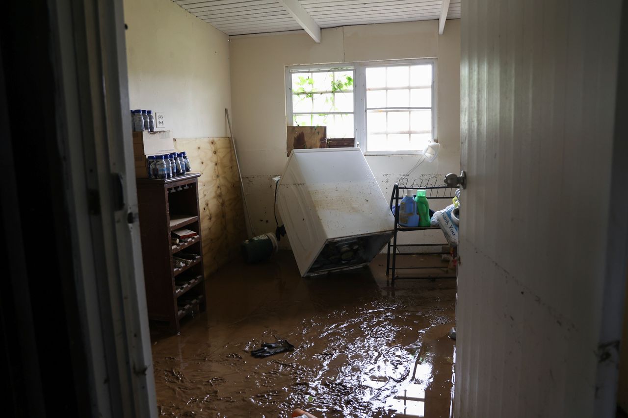 Mud covers the floor of a home flooded in Cayey, Puerto Rico, on Tuesday.