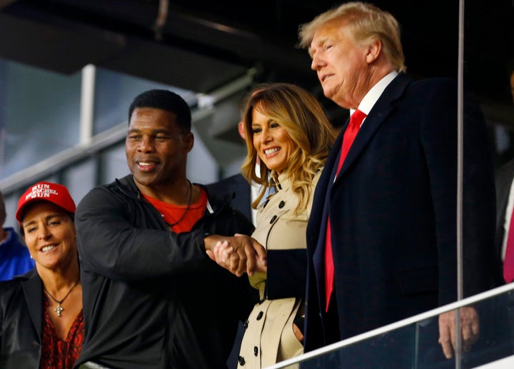 Herschel Walker interacts with former President Donald Trump prior to Game 4 of the World Series between the Houston Astros and the Atlanta Braves on Oct. 30, 2021, in Atlanta, Georgia.