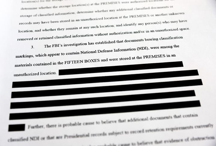 CALIFORNIA - AUGUST 27: In this photo illustration, a page is viewed from the government’s released version of the F.B.I. search warrant affidavit for former President Donald Trump's Mar-a-Lago estate on August 27, 2022 in California. The 32-page affidavit was heavily redacted for the protection of witnesses and law enforcement and to ensure the ‘integrity of the ongoing investigation’. (Photo Illustration by Mario Tama/Getty Images)