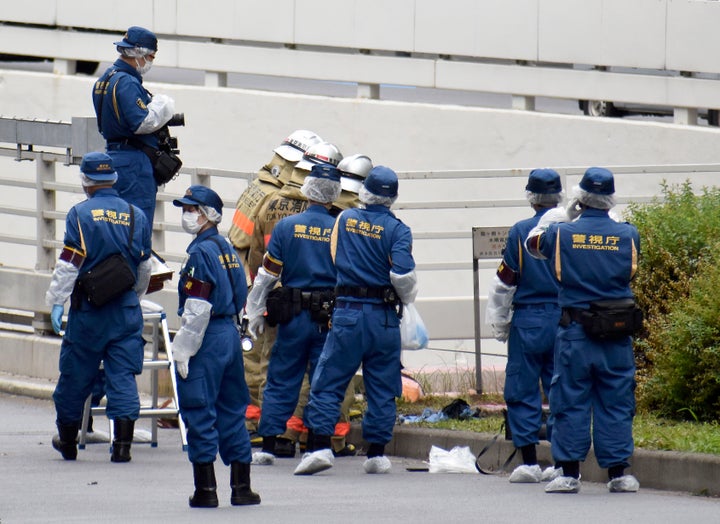 Police and firefighters inspect the scene where a man is reported to set himself on fire, near the Prime Minister's Office in Tokyo, on Sept. 21, 2022.