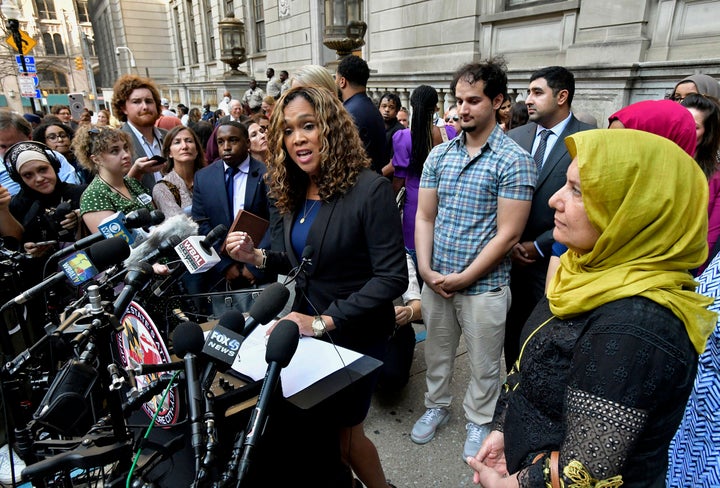State Attorney Marilyn Mosby (left) discusses the release of Adnan Syed after his conviction was overturned on Monday. Syed's mother, Shamim Syed (right), looks on with another son standing behind Mosby.